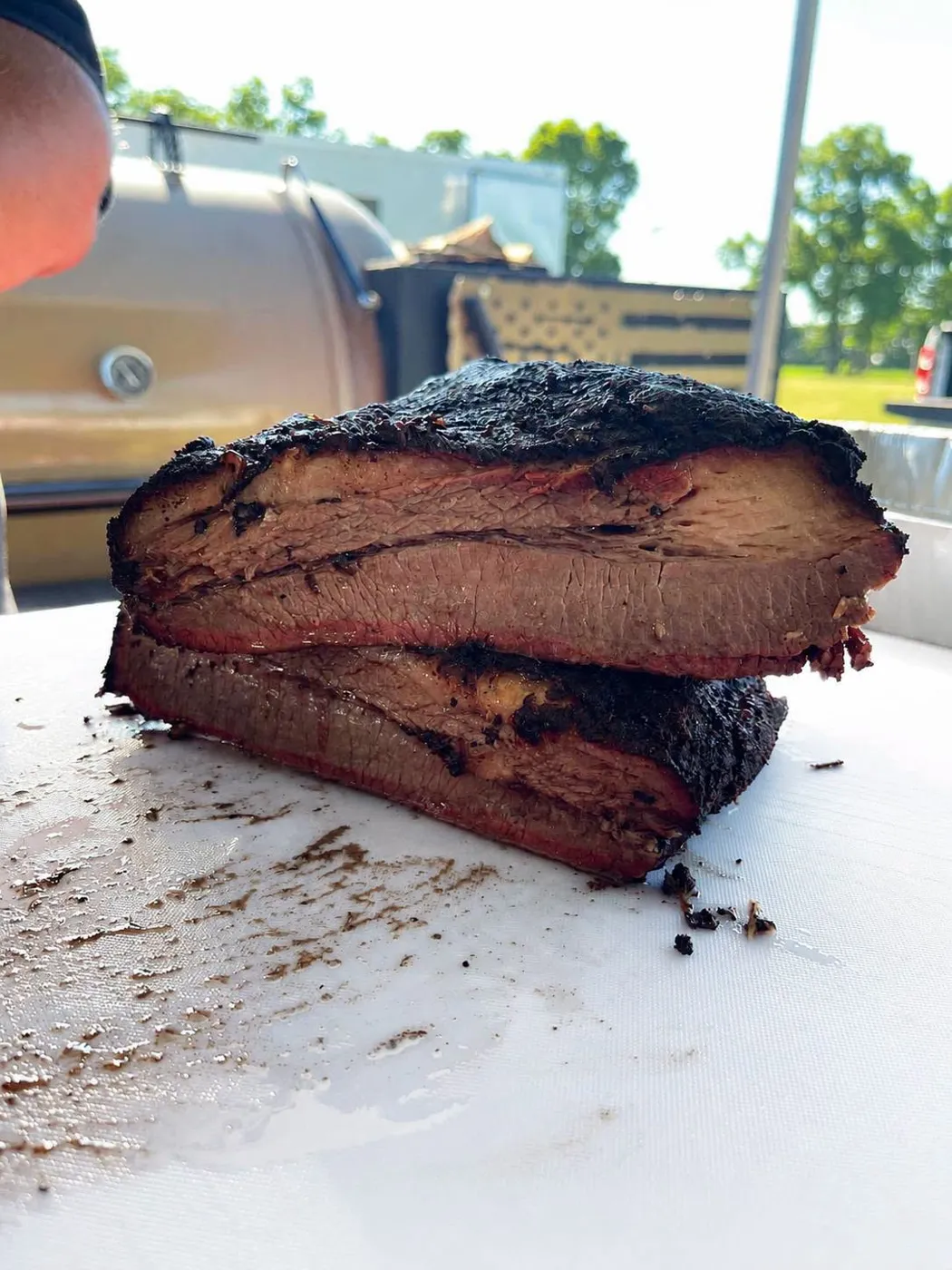 Thick slices of smoked brisket with bark and smoke ring